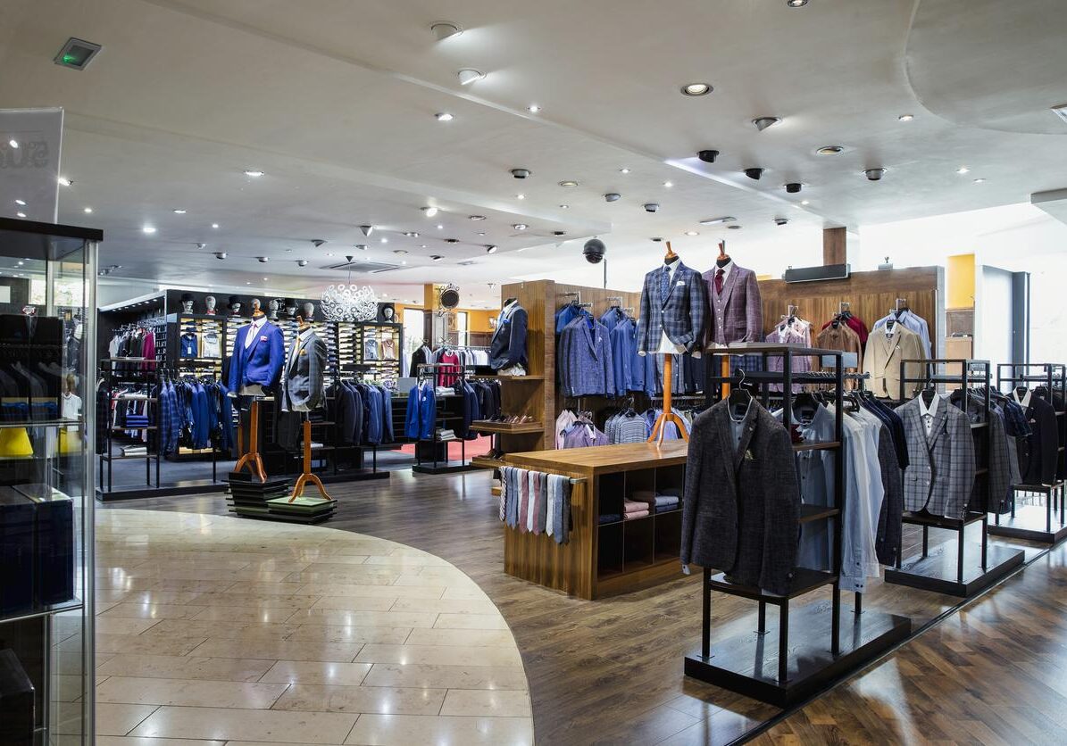 Interior of a high-quality clothing shop for men with many suits and neckties on display
